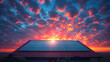 A solar panel on the roof of an urban house with a red tile roof, against the background of sunset and clouds. 16:9