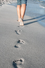 Wall Mural - beautiful traces with feet near the sea on nature background