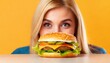 © Marko - young woman peeking at cheeseburger on table