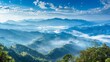 Breathtaking mountain panorama with clouds - An awe-inspiring panoramic view of cloud-covered mountain peaks bathed in sunlight highlights the beauty of nature