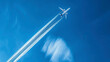 airplane tracks in the air, blue sky background, plane tracks in the sky