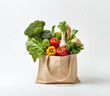 A shopping bag with fresh vegetables isolated on a white background