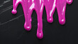 dripping pink paint on black background