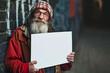 © mila103 - A mystical drunk holds a white sign with a mysterious expression on his face