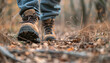 Journey to the Summit. Close-up shot of leather hiking boots trekking in a rocky trail in forest, showcasing the rugged terrain and the perseverance and determination of the hiker. 