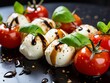 Caprese with cherry tomatoes, mozzarella balls and basil leaves, poured with balsamic glaze