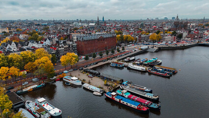 Wall Mural - Aerial drone view Amsterdam autumn cityscape narrow old houses, canals, boats bird's eye view