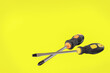 A screwdriver. A working tool. Flat and phillips screwdrivers on a yellow background. Copy space