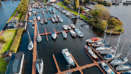 Wall Mural - Aerial drone view Amsterdam autumn cityscape narrow old houses, canals, boats bird's eye view