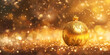 A gold Christmas ball sits on a gold background with a feather in the foreground  defocused lights with decorated tree Happy New Year.