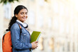 © Prostock-studio - Happy Indian student with working books outside
