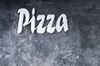 Pizza word written on dark table