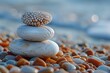 Macro shot of a stack of balanced Zen stones on a pebbly beach showcasing texture and the concept of harmony