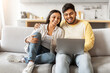© Prostock-studio - Loving Indian couple relaxing with laptop home
