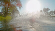 LENS FLARE Unknown adventurous person jumps into water and creates a huge splash