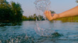 CLOSE UP: Female gently splashes water with hand while she is bathing in river