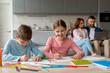 © Prostock-studio - Children doing homework with parent's support, home interior