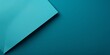 Cyan background with dark cyan paper on the right side, minimalistic background, copy space concept, top view, flat lay, high resolution