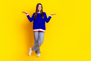 Sticker - Full length photo of pretty teen girl compare empty space wear trendy knitwear blue outfit isolated on yellow color background