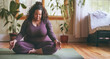 © LorenaPh - Plus size mixed race woman meditating at home after yoga class. Copy space for advertisement