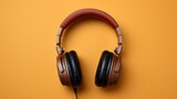 Fototapeta Uliczki - Aerial view of headphones against a brown background
