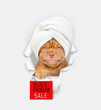 Smiling Mastiff puppy with towel on it head looking through a hole in white paper and showing signboard with labeled 