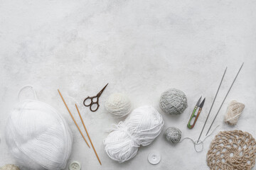 Wall Mural - Knitting needles, yarn balls and scissors on white background