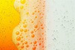 Abstract background of water drops on glass with orange and yellow background