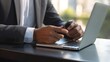© CStock - businessman hands typing on a keyboard or scrolling through a smartphone,