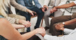 © peopleimages.com - People, group and therapy for mental health, holding hands and listening with advice, empathy and kindness. Conversation, men and women with communication, meeting or consultation with therapist