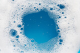 Fototapeta Mapy - Detergent foam bubble on wate. Blue background, Soap sud