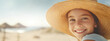 Smiling Young Girl in Straw Hat Enjoying Sunny Beach Day