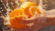 Fresh Oranges Squeezed by Hand with Splashing Water