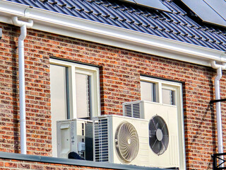 Wall Mural - air source heat pump unit installed outdoors at a modern home with solar panels in the Netherlands, Zonnepanelen, Warmte pomp, Translation: Solar panel, Air source Heat pump