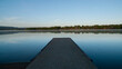 Dock on a still lake in springtime at sunrise