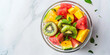 a strange of fresh watermelon, mango and kiwi salad in a glass bowl on a light background, generative AI