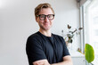 © Austockphoto - Portrait of 20-something man standing in an office