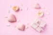 Festive background for Birthday, Woman or Mothers Day. Pink hearts, rose flowers and gift box on table top view. Flat lay.