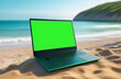 Mockup image of laptop with blank green screen on a sandy beach. Advertising layout for a travel agency