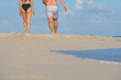 Couple walk on beach.