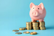 © Pattra - piggy bank on coins, blue background.