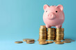 © Pattra - finance piggy bank and coin on blue background.