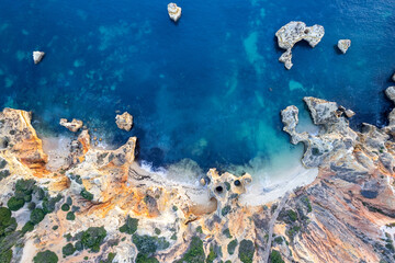 Wall Mural - Sunrise over Ponta de Piedade, Algarve cliffs on coastline. Aerial drone view