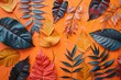A variety of leaf shapes and colors to construct an eye-catching composition on a bright orange canvas