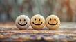 Three wooden smiley balls on a textured surface. Close-up with soft focus background.