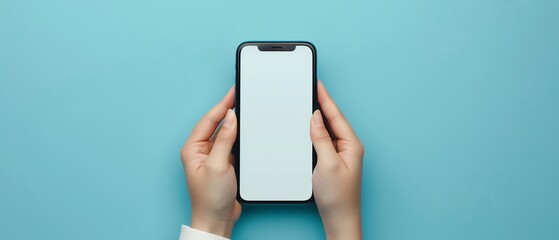 A person holding a black phone with a blank screen in front of a blue background.