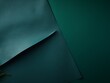 Green background with dark green paper on the right side, minimalistic background, copy space concept, top view, flat lay