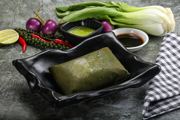 Wall Mural - Asian cuisine - rice with filling in banana leaf