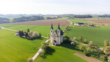Fototapeta Miasta - Heiligenkreuz , Upper Austria, Austria - 04.13.2024: church of Heiligenkreuz in Upper Austria, aerial photography