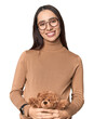 Pregnant Caucasian woman holding teddy bear